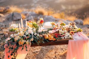 decorated-table-wedding-celebration-with-bouquet-white-roses-fruits-cake